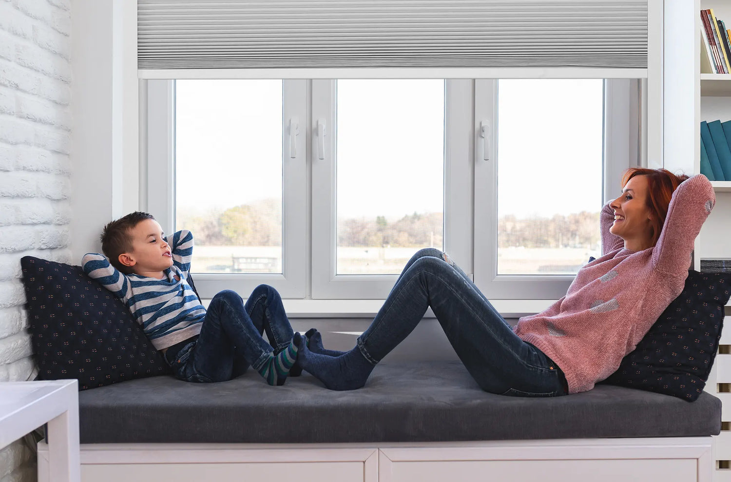 A child playing safely near Kurlax cordless motorized cellular shades.