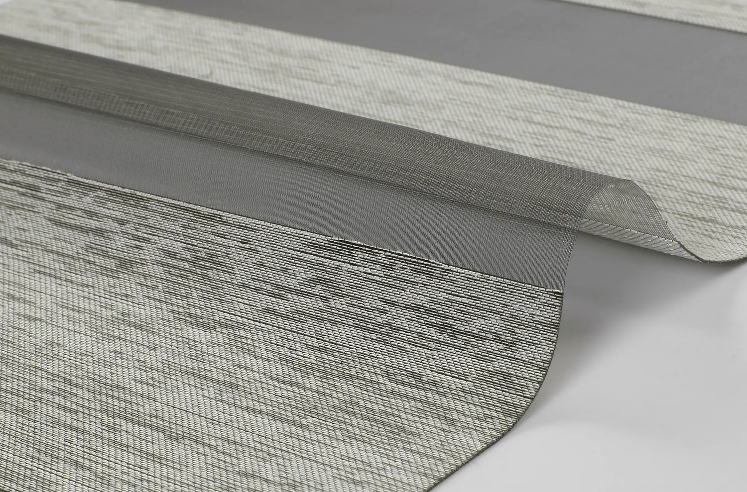 Close-up of Kurlax Elite Privacy Series 100% polyester zebra shade fabric showing texture and light filtering effect.