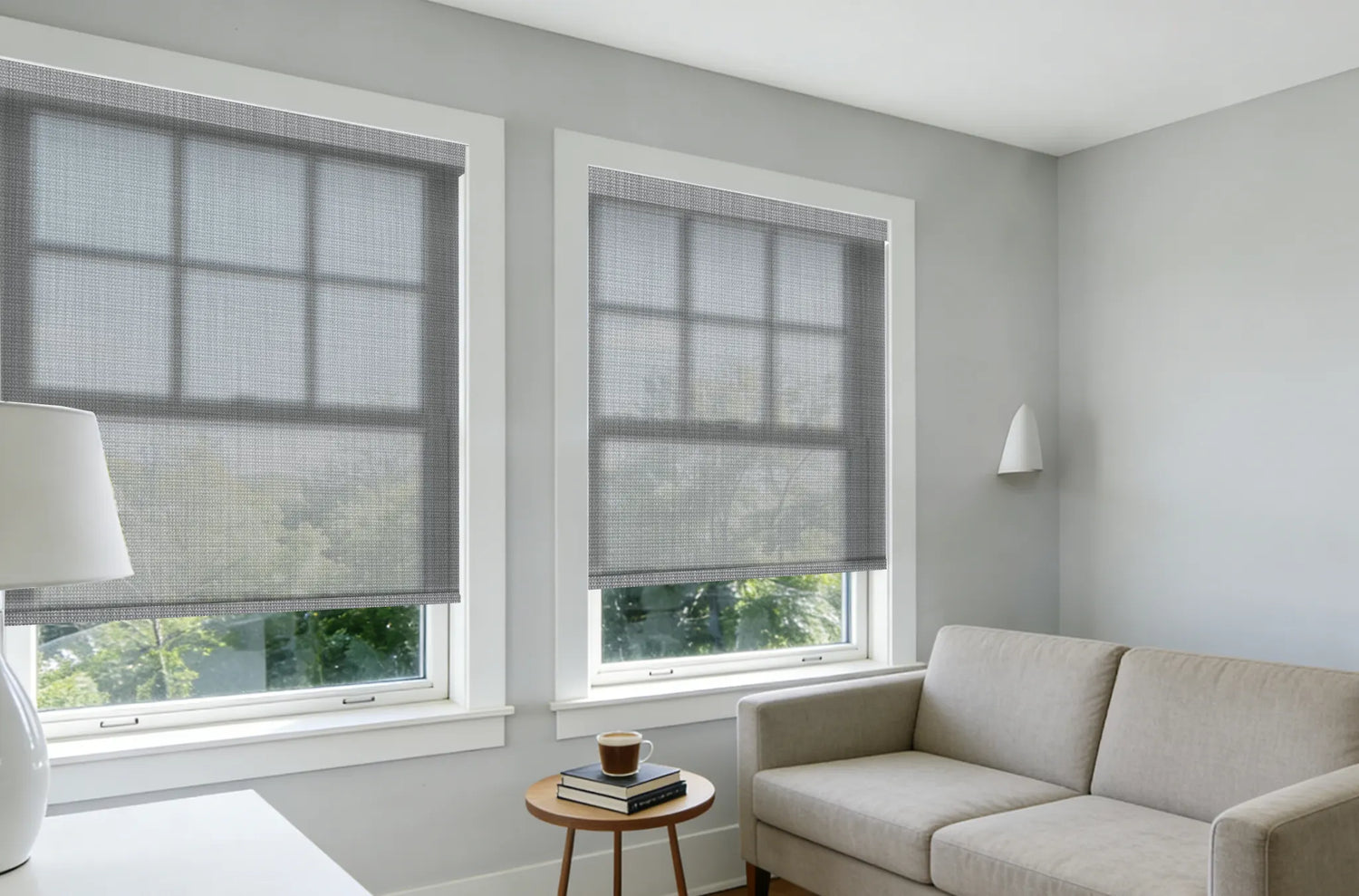 Modern living room featuring Kurlax custom motorized solar roller shades in Light Gray.