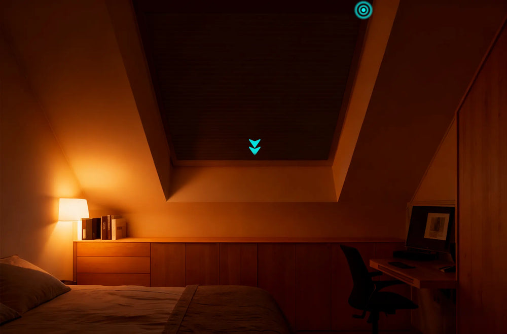 Fully closed motorized 100 percent blackout skylight cellular shades on an inclined bedroom skylight