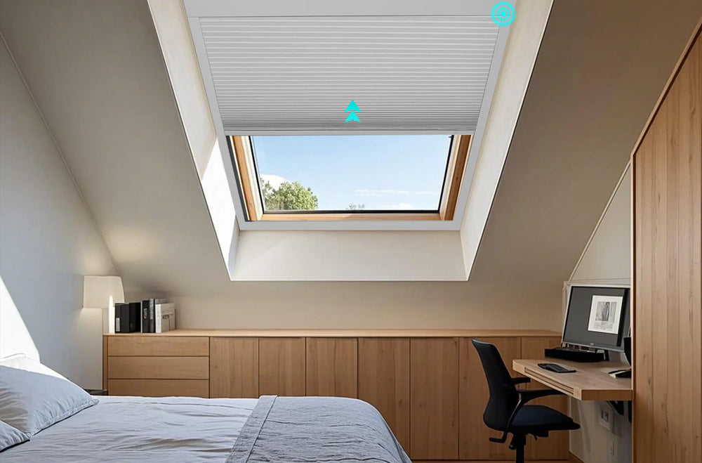 Motorized 100 percent blackout skylight cellular shades half-open on an inclined bedroom skylight