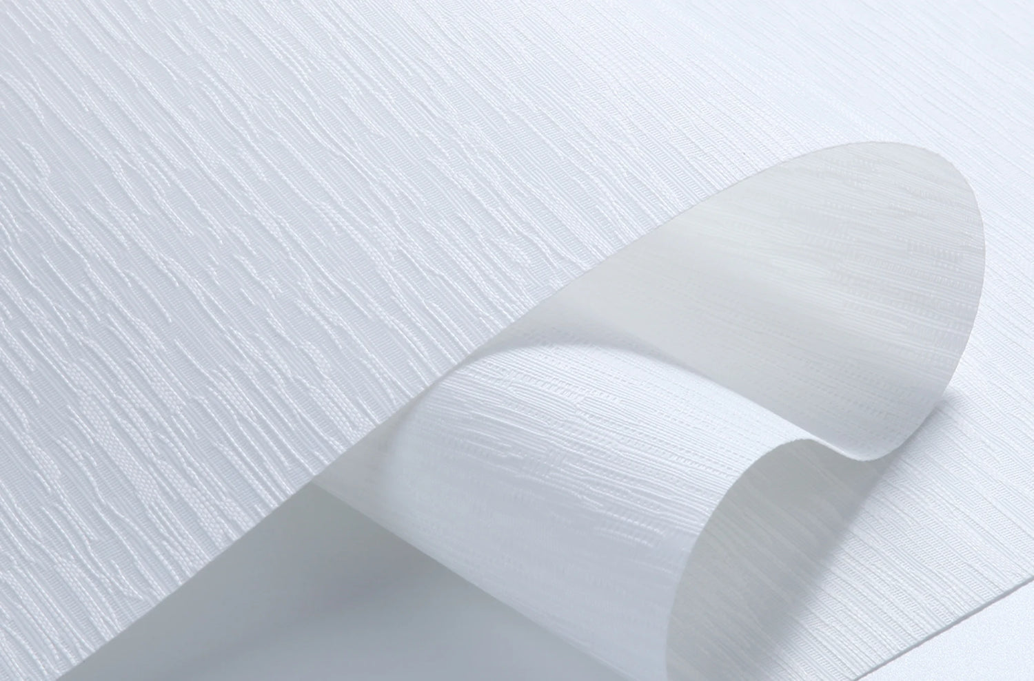 Close-up texture of a white Ramie Jacquard fabric roller shade, showcasing the weave and light filtering quality.