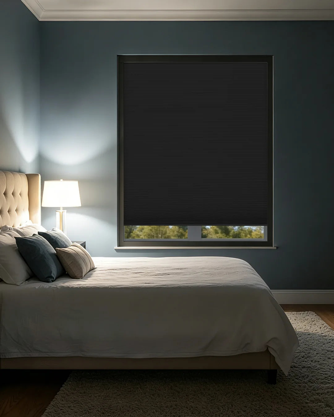 Kurlax blackout cellular shades providing total darkness and quiet in a modern master bedroom.