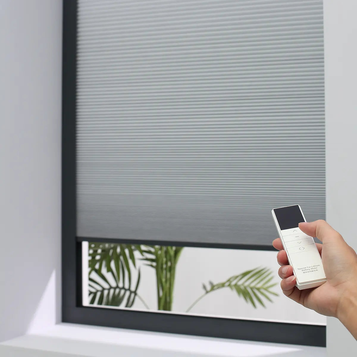 Modern remote control for Kurlax motorized blinds.