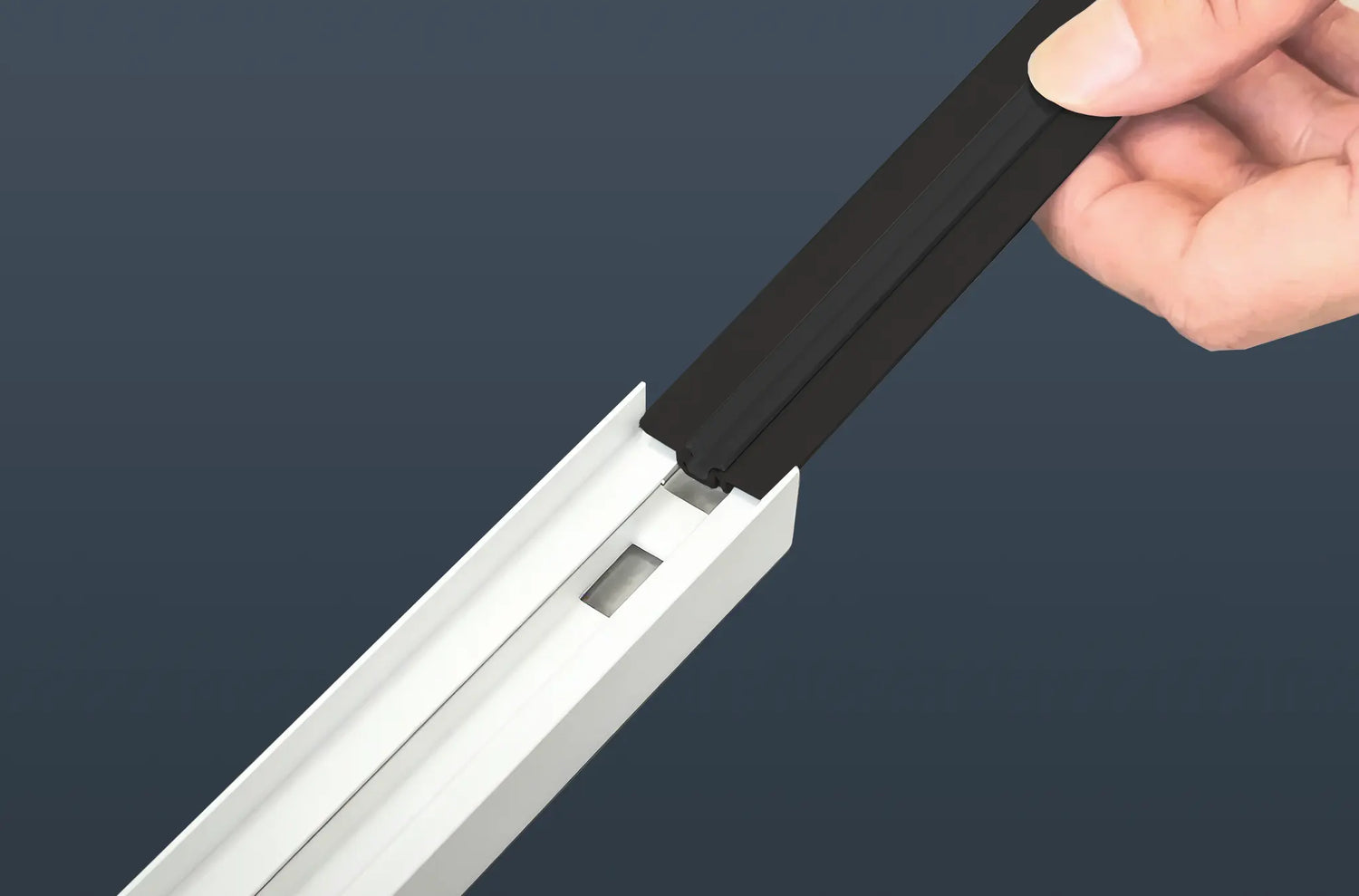 Inserting the magnetic strip into the bottom rail and rubber strips into the side rails of the Sleep-Guard frame.