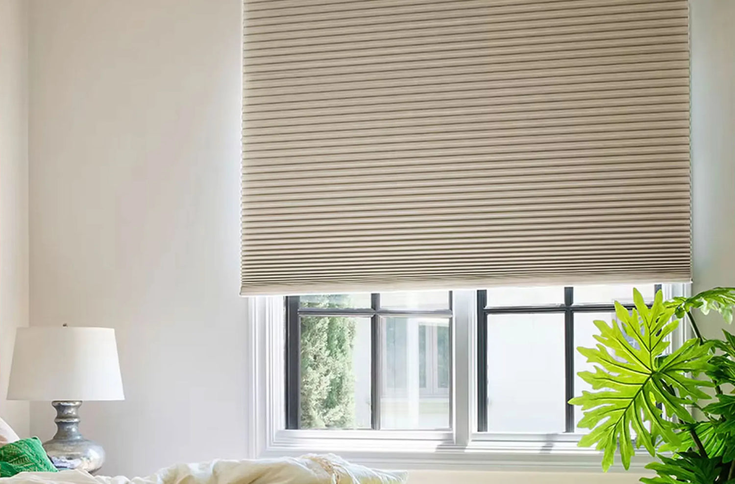Smart home scene with Kurlax motorized shades closing automatically in the evening light.